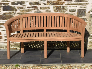 Front view of curved teak banana bench garden seat
